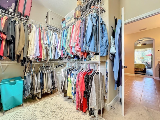 spacious closet featuring ceiling fan and tile patterned flooring