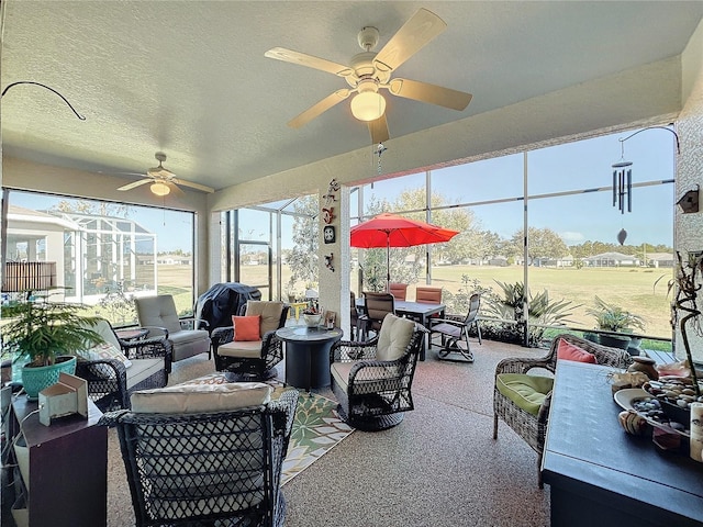 sunroom / solarium featuring ceiling fan