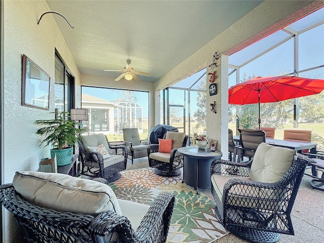 sunroom featuring ceiling fan