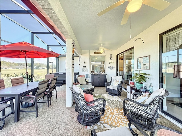 view of patio / terrace featuring glass enclosure, outdoor lounge area, and a hot tub