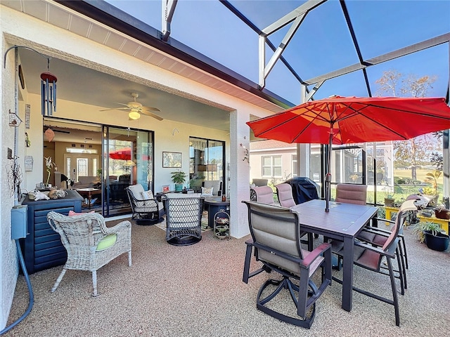 view of patio with glass enclosure and ceiling fan