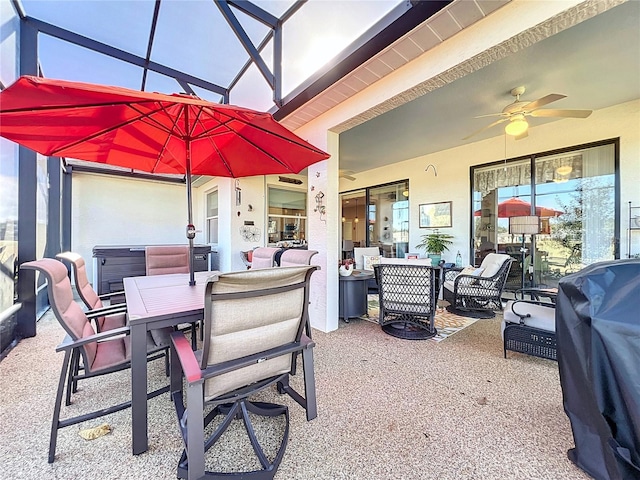 view of patio with area for grilling, ceiling fan, and a lanai