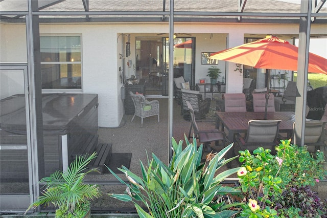 view of patio featuring glass enclosure