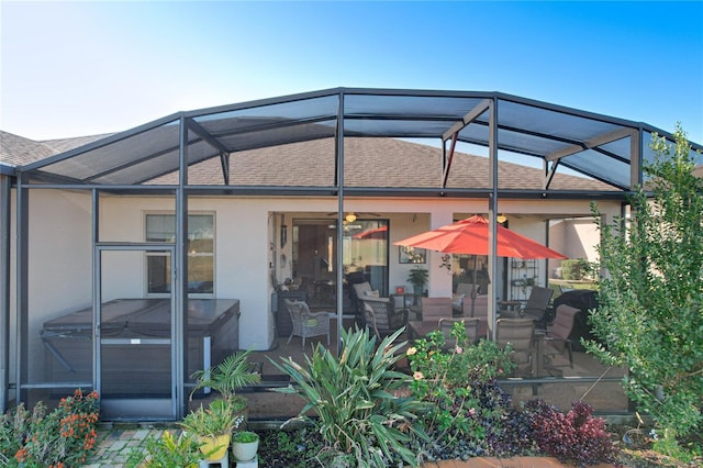 back of property with a lanai and a patio