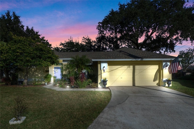 ranch-style house featuring a lawn and a garage