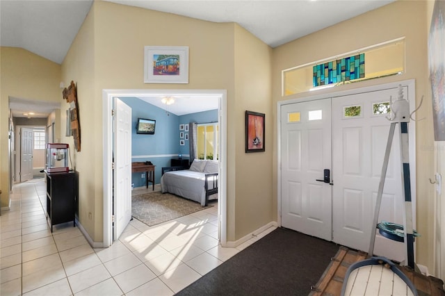 foyer entrance featuring lofted ceiling and light tile patterned floors