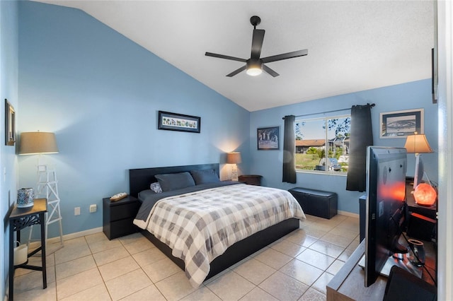 bedroom with light tile patterned floors, vaulted ceiling, and ceiling fan