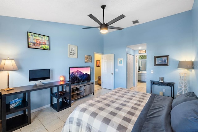 tiled bedroom with connected bathroom, ceiling fan, and vaulted ceiling