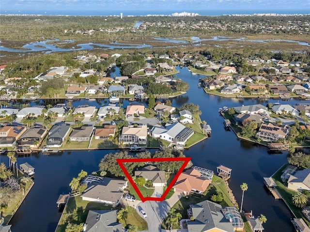 drone / aerial view featuring a residential view and a water view