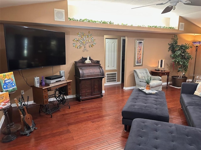 living room featuring dark hardwood / wood-style floors, vaulted ceiling, and ceiling fan