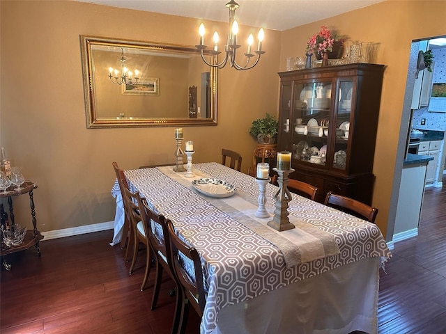 dining room featuring dark hardwood / wood-style floors and a notable chandelier