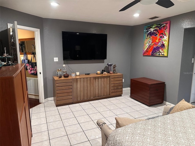 tiled bedroom featuring ceiling fan