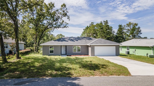 single story home featuring cooling unit, a front lawn, and a garage