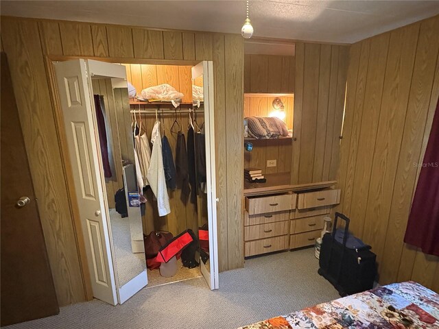 975 Crk 461, Lake Panasoffkee, FL 33538 - bedroom with a spacious closet, light colored carpet, wood walls, and a closet