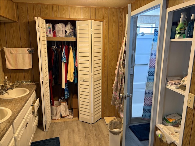 975 Crk 461, Lake Panasoffkee, FL 33538 - bathroom with vanity, hardwood / wood-style floors, and wooden walls