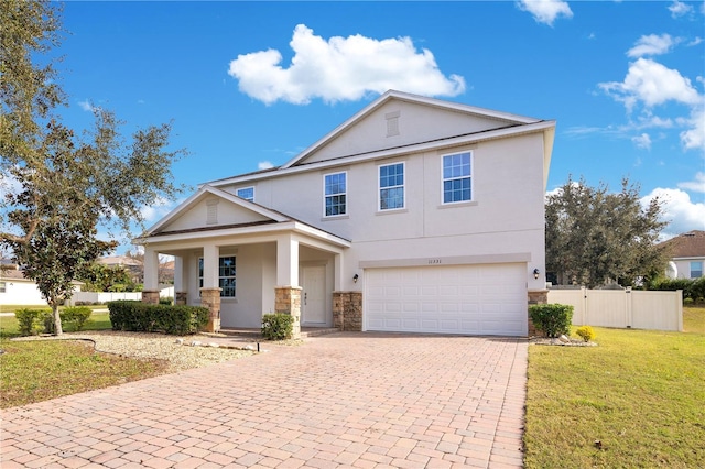 view of front of house with a garage, a front lawn, and covered porch