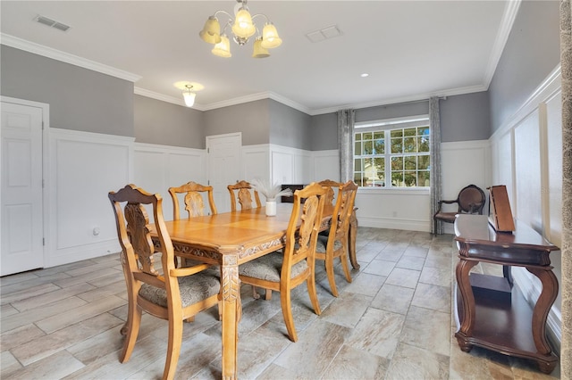 dining space featuring crown molding and a chandelier