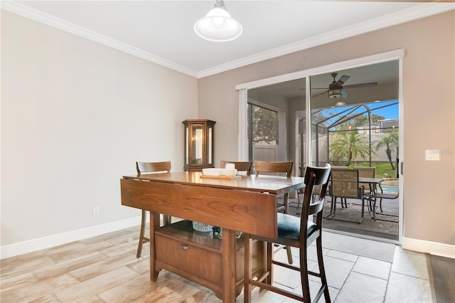 dining area with crown molding and ceiling fan