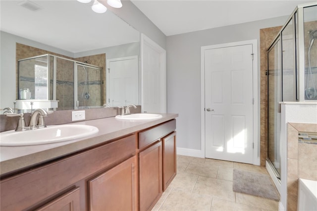 bathroom featuring a shower with shower door, tile patterned floors, and vanity