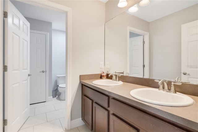 bathroom featuring tile patterned floors, vanity, and toilet