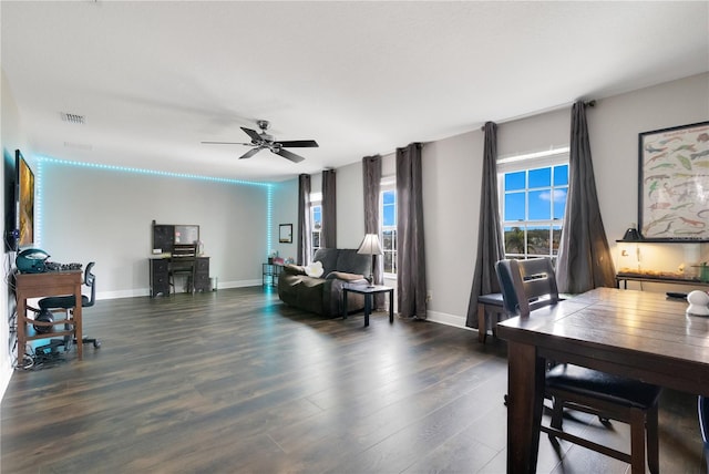 home office with dark hardwood / wood-style floors and ceiling fan