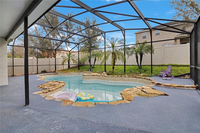 view of swimming pool with a lanai and a patio area