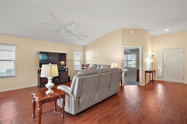 living room featuring hardwood / wood-style flooring, vaulted ceiling, and ceiling fan