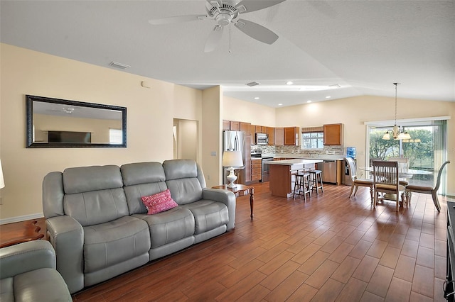 living room with dark wood-type flooring, ceiling fan, and lofted ceiling