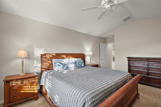 carpeted bedroom with ceiling fan and vaulted ceiling