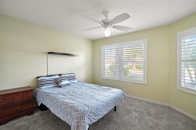 carpeted bedroom with multiple windows and ceiling fan