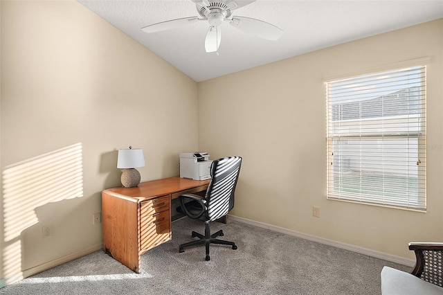 carpeted office space featuring ceiling fan