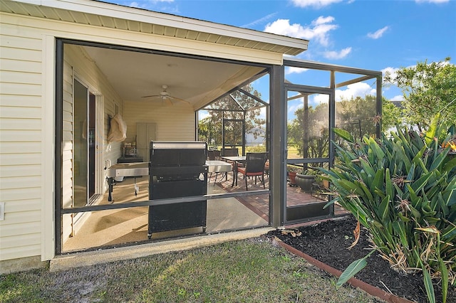 view of patio featuring a sunroom and ceiling fan