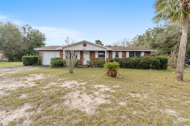 single story home featuring a front lawn and a garage