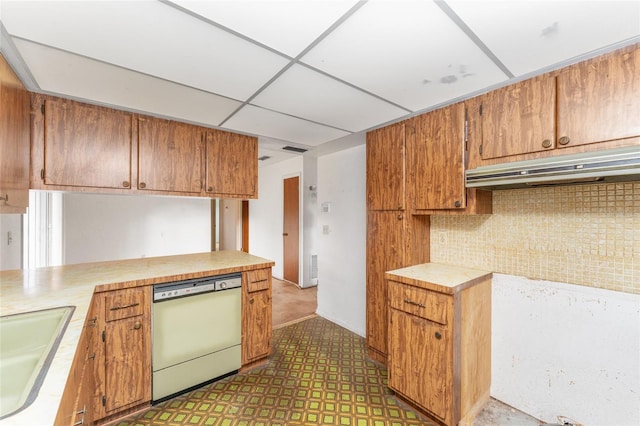 kitchen featuring a paneled ceiling, decorative backsplash, dishwasher, and sink