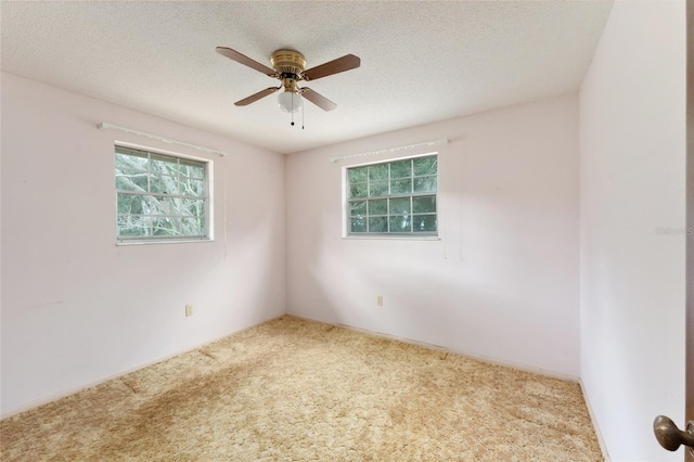 unfurnished room featuring carpet flooring, a textured ceiling, and ceiling fan