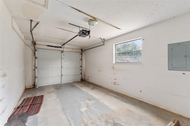 garage with a garage door opener and electric panel