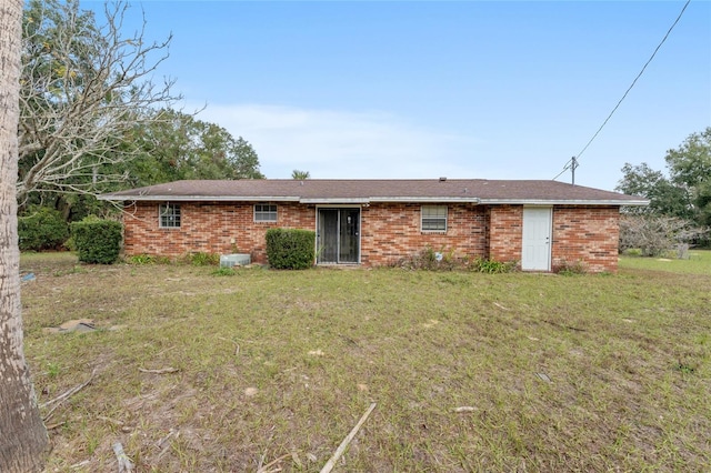 rear view of house featuring a yard