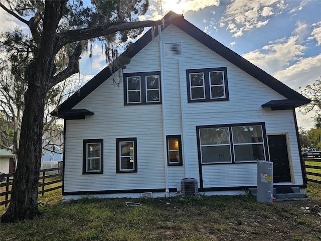 back of house with central AC