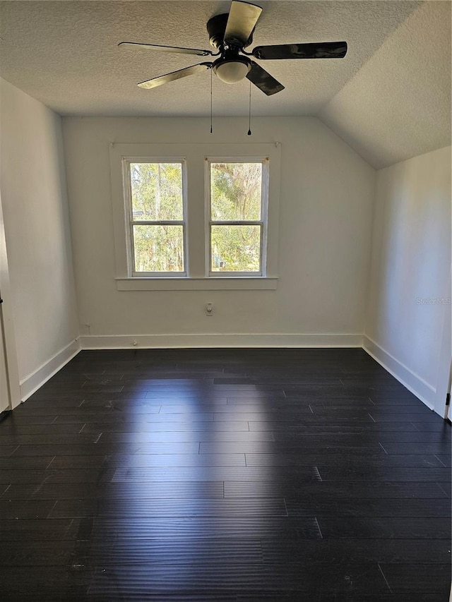 interior space featuring a textured ceiling, dark hardwood / wood-style floors, vaulted ceiling, and ceiling fan