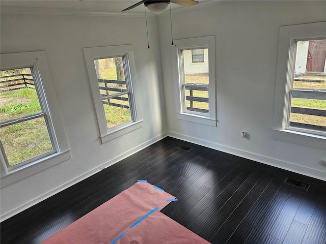 spare room featuring ceiling fan, dark hardwood / wood-style floors, and ornamental molding