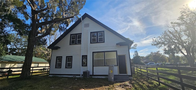 rear view of property with central AC