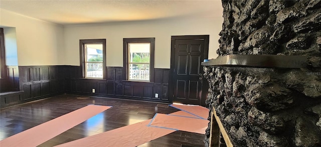 interior space featuring dark wood-type flooring and ornamental molding