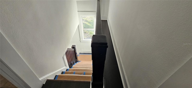 staircase featuring lofted ceiling