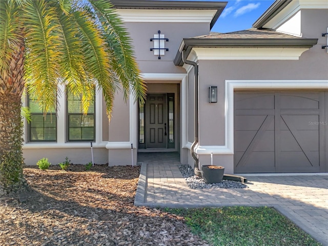 doorway to property with a garage