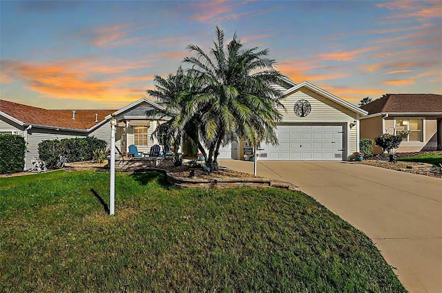 view of front of property with a lawn and a garage