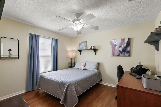 bedroom featuring ceiling fan, dark hardwood / wood-style floors, and a textured ceiling