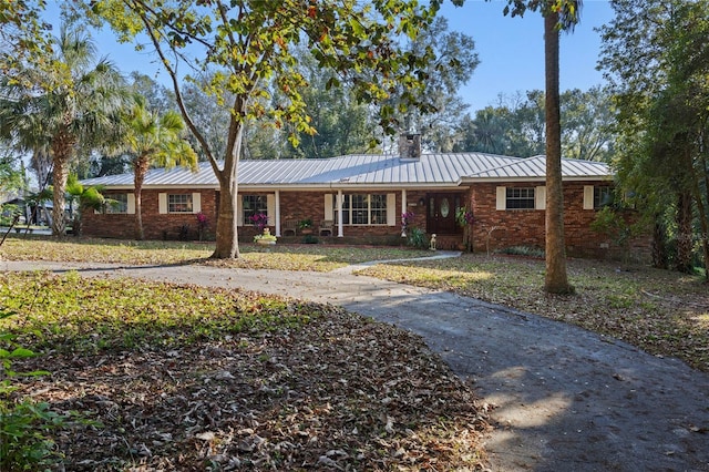 ranch-style home featuring a front yard