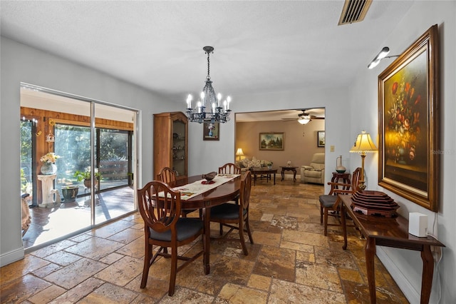 dining room with ceiling fan with notable chandelier