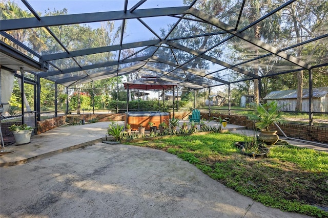 view of patio / terrace featuring a hot tub and a lanai