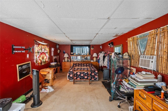 bedroom featuring a paneled ceiling and cooling unit